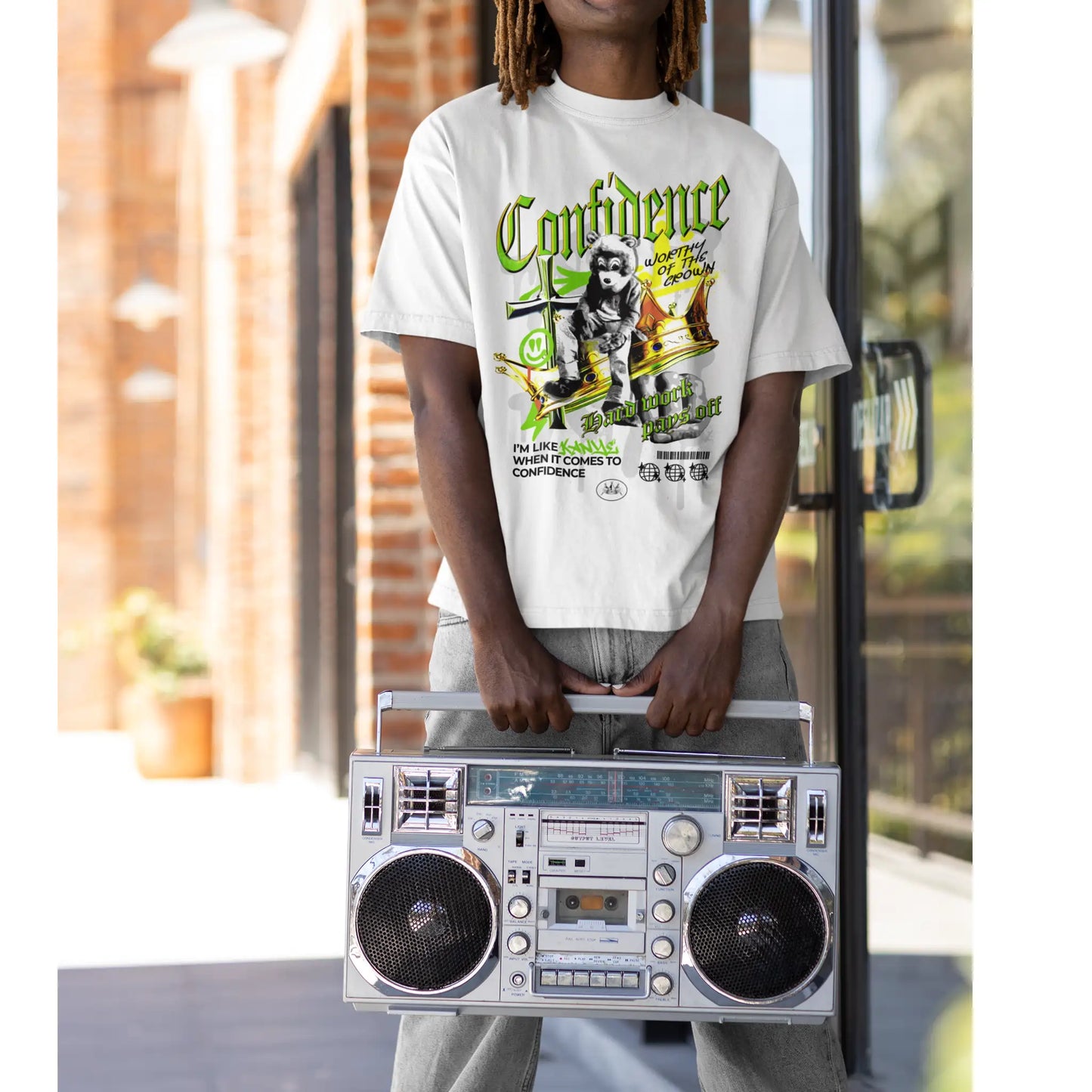 Young man wearing Confidence  tee holding a boom box 