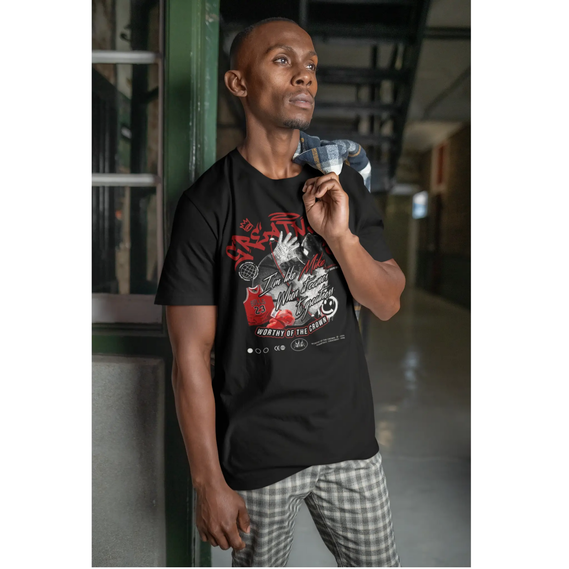 Male model with shirt over his shoulder wearing Greatness tee